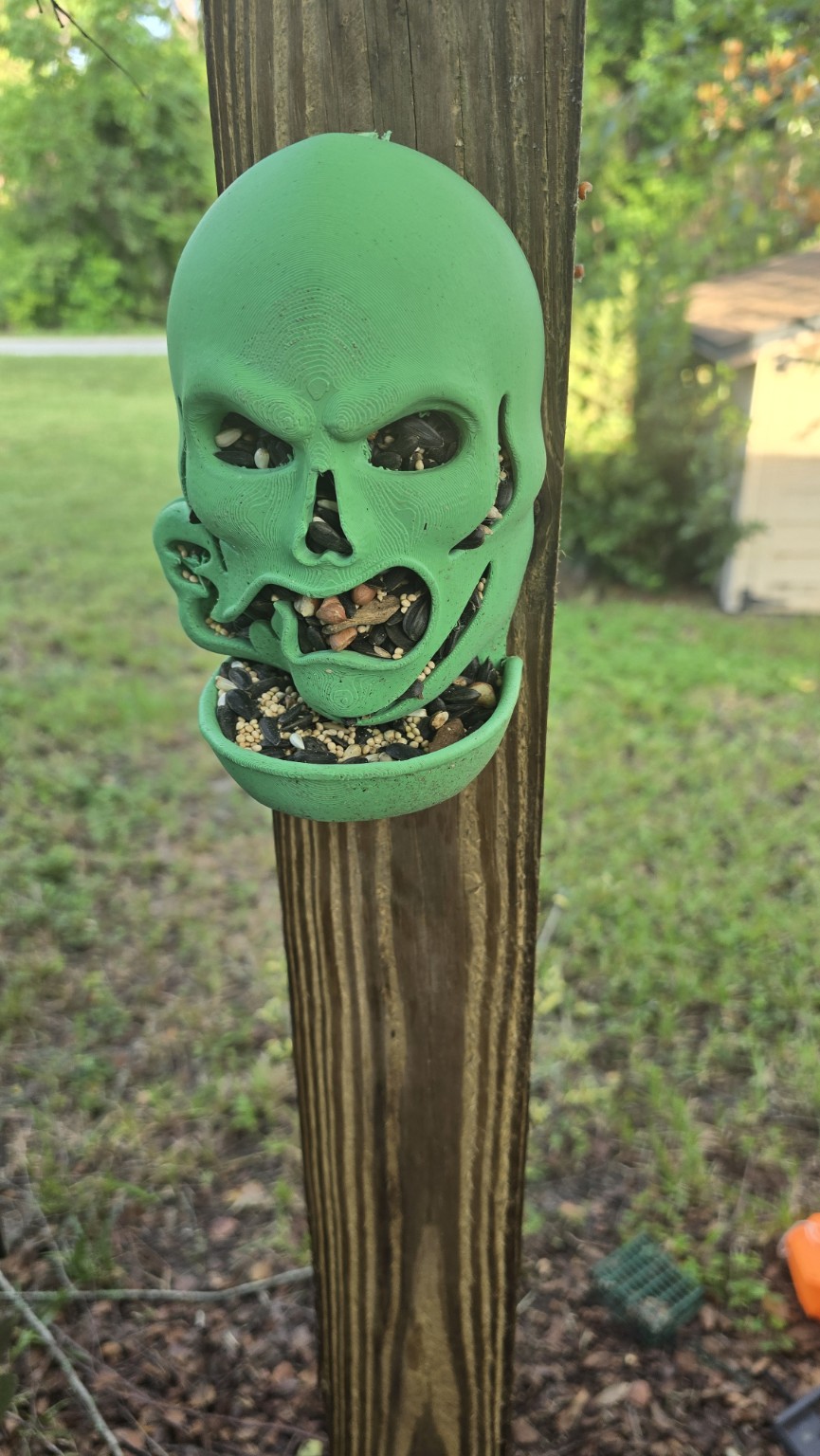 Green skull-shaped 3D printed outdoor feeder
