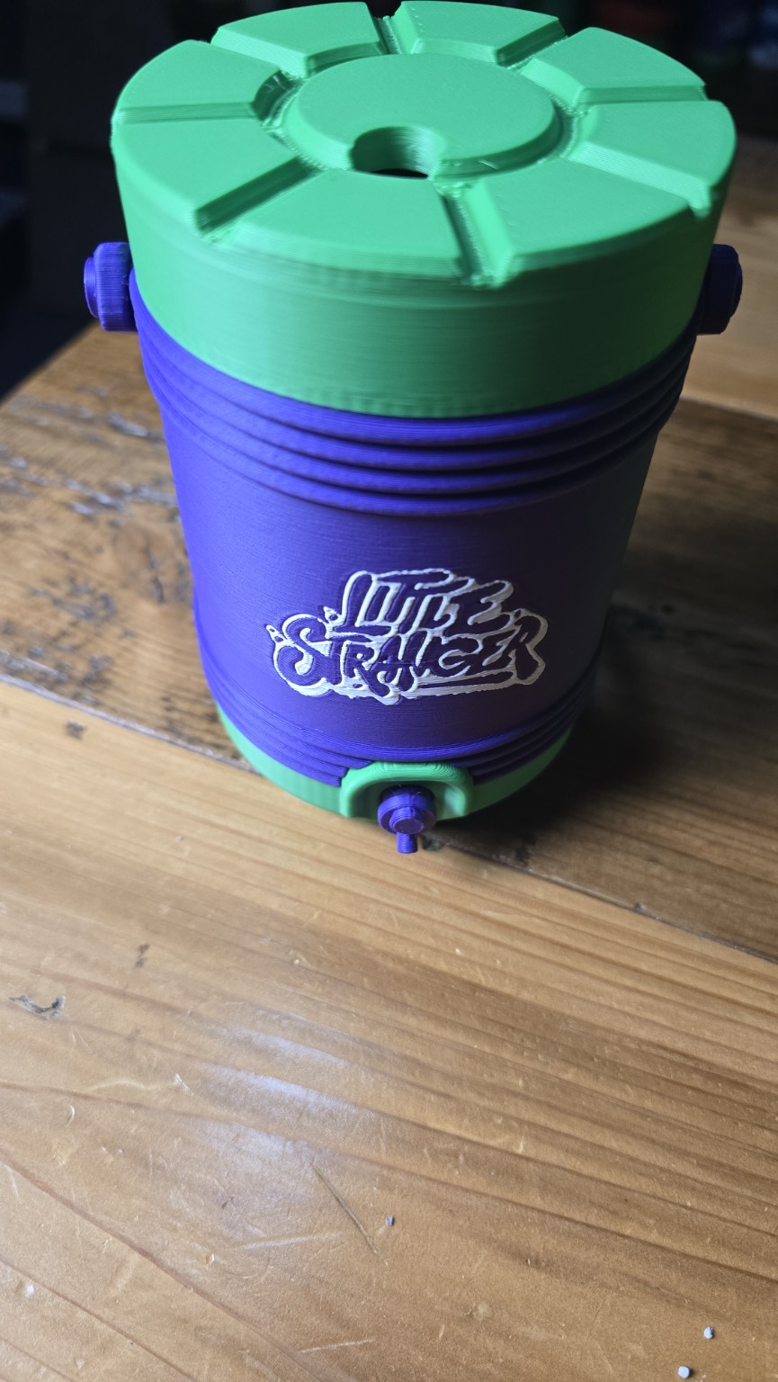 Closed purple and green Little Stranger container