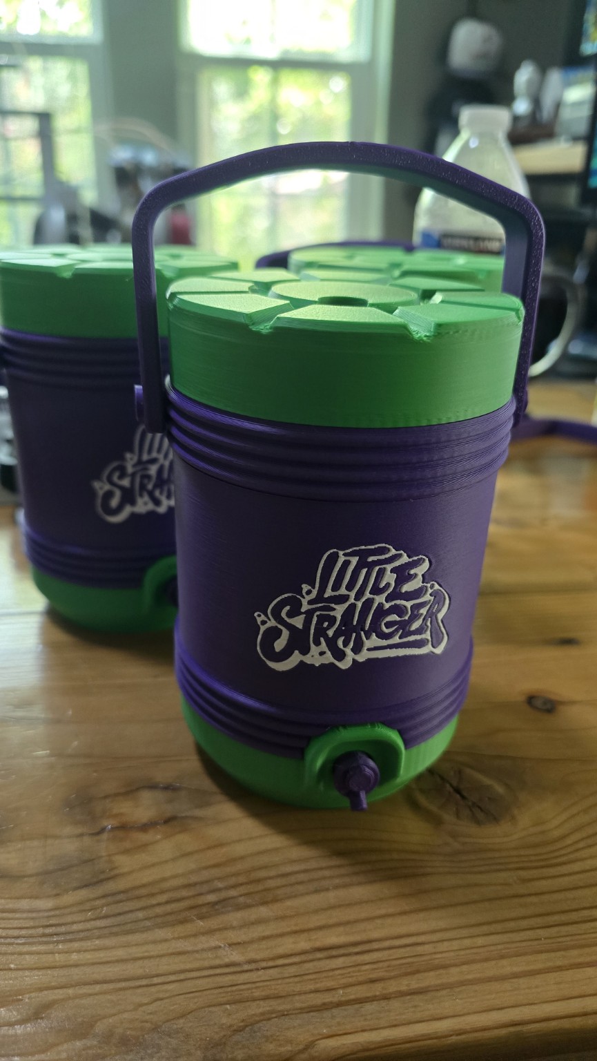 Purple and green Little Stranger container with carrying handle