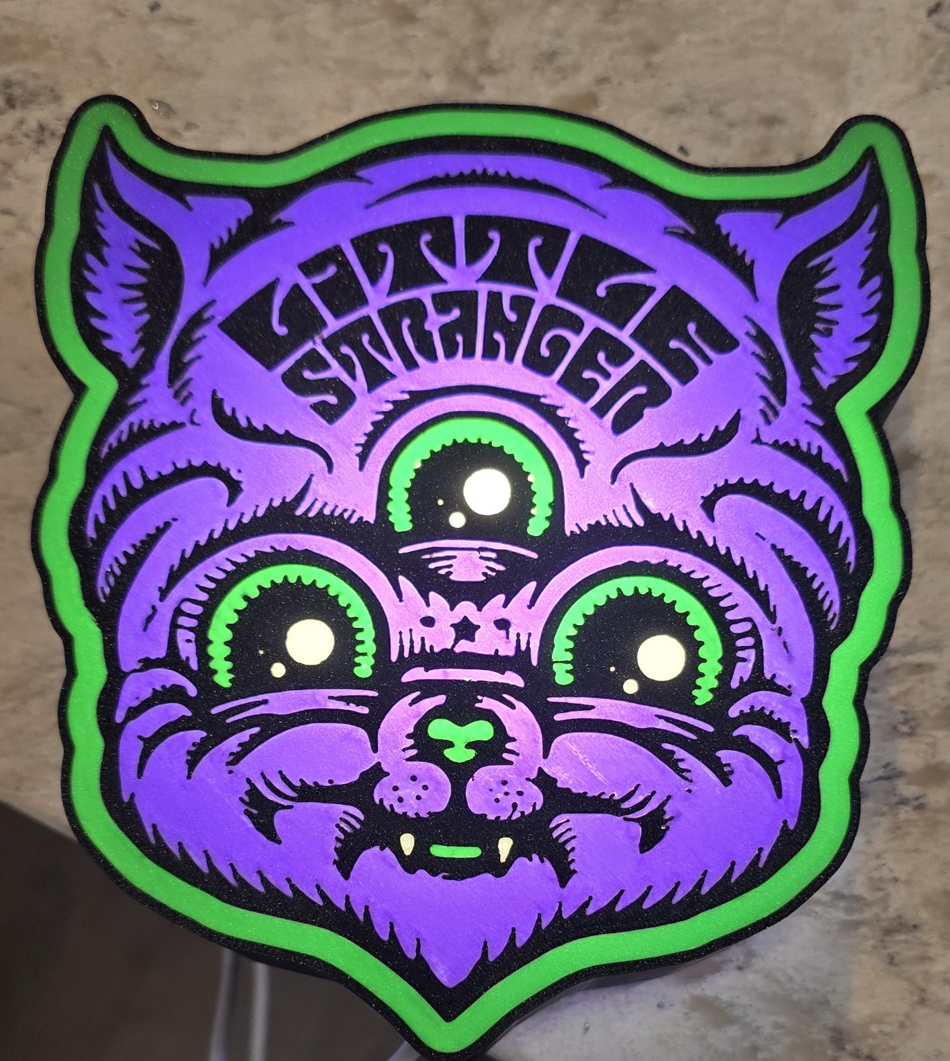 Purple green and black layered three-eyed cat artwork