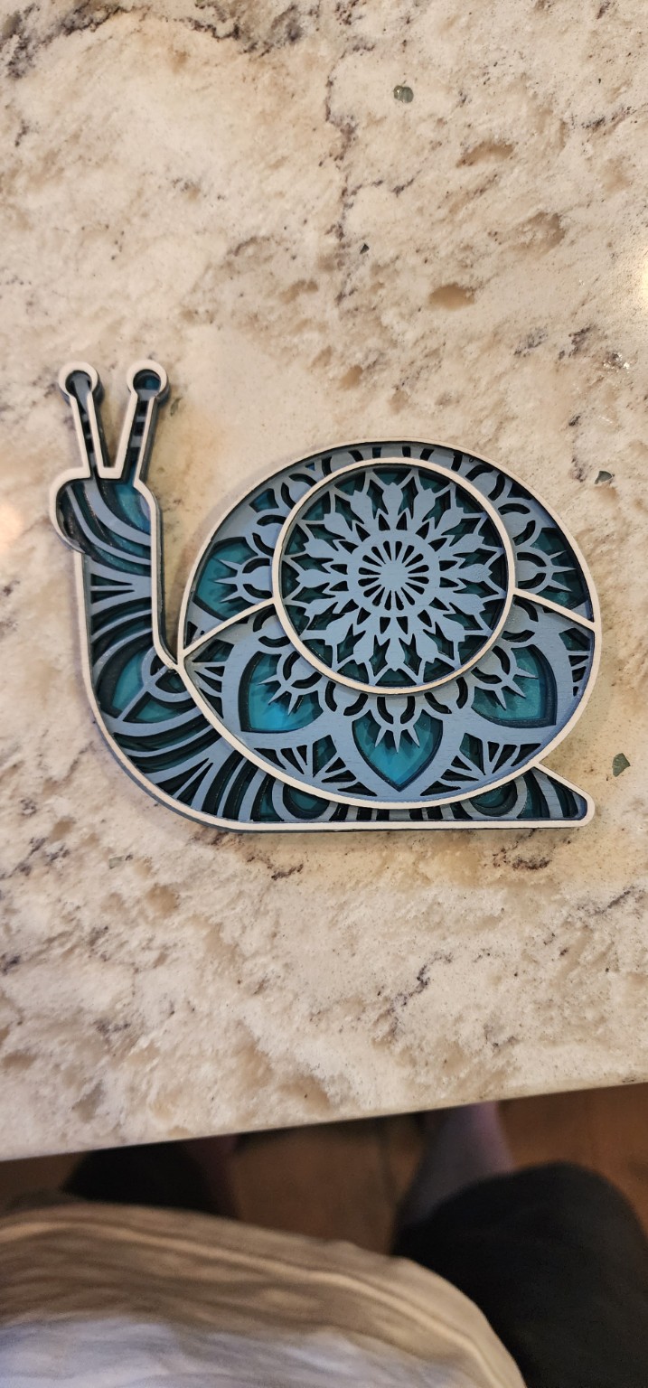 Blue layered snail with a mandala shell