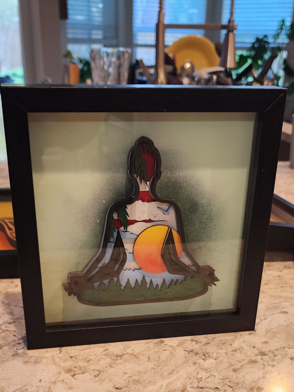 Layered meditation artwork in a black shadowbox