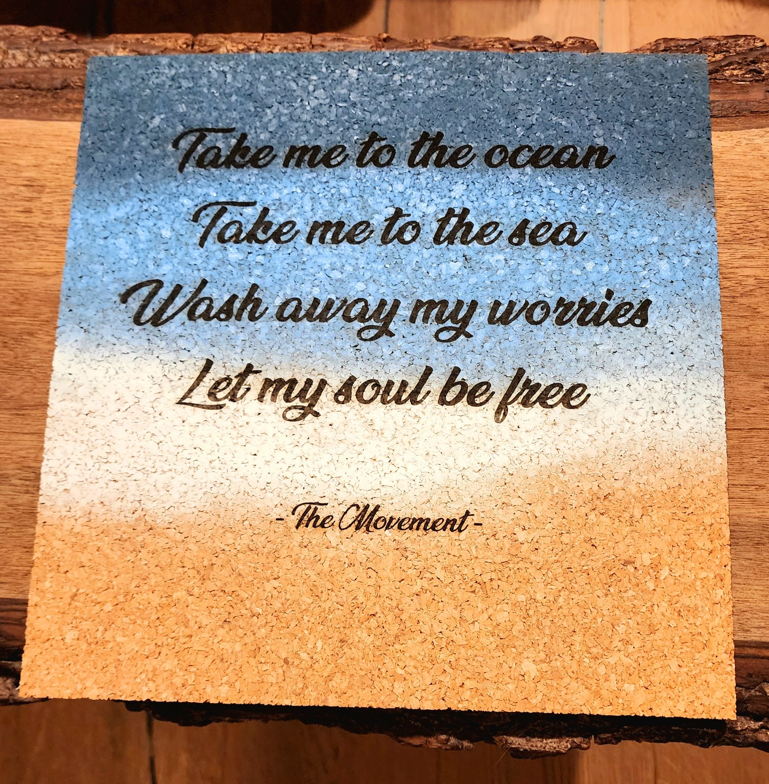 Engraved ocean quote on a blue and sand-colored plaque