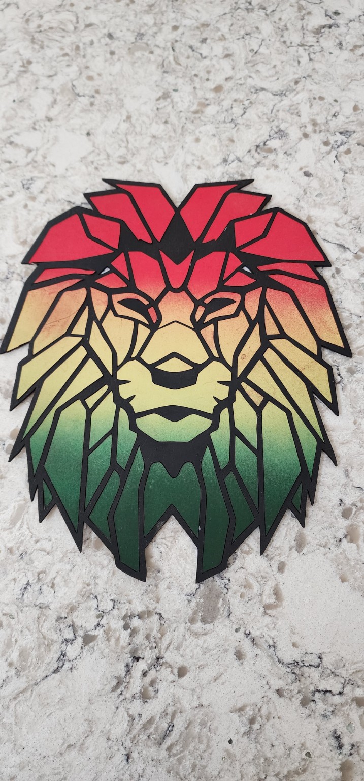 Layered geometric lion artwork in red yellow and green