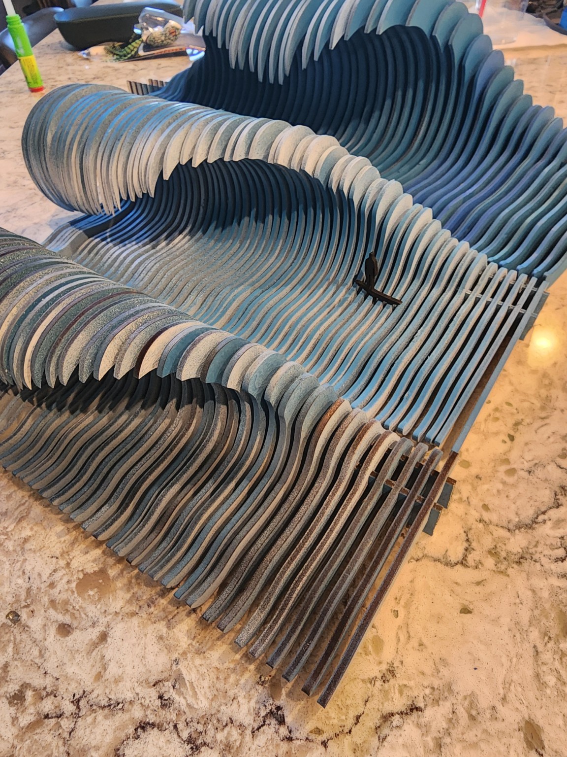 Freestanding dimensional wave sculpture made from stacked wood layers