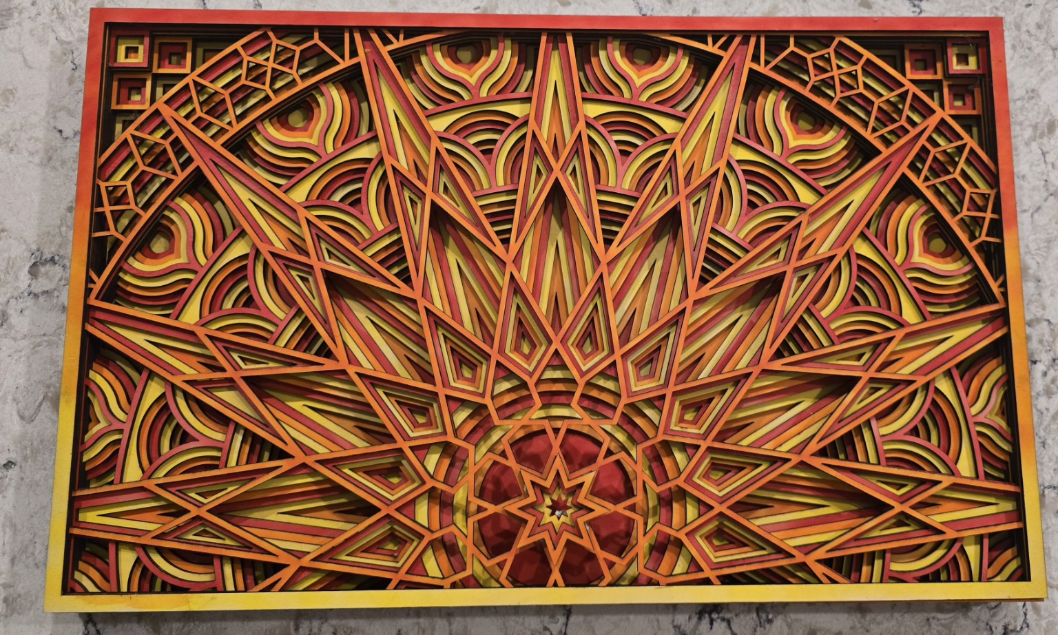 Colorful layered laser-cut geometric artwork
